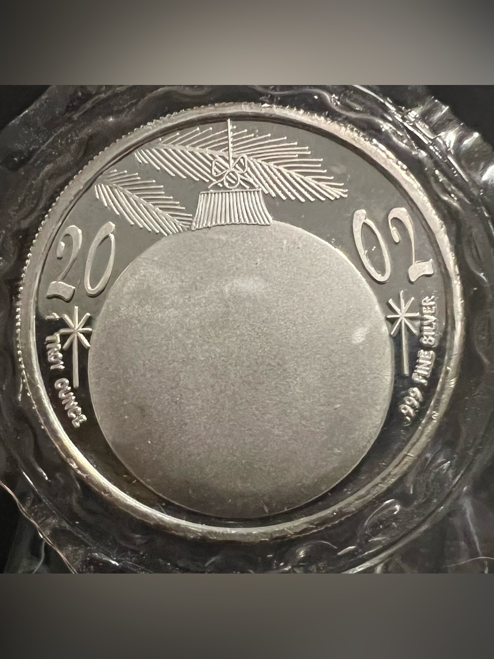2002 1 oz.999 fine silver round with a Christmas ornament design.